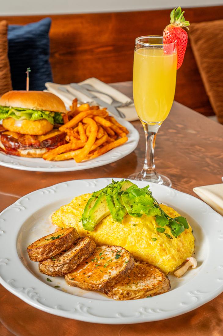 Omelette with potatoes, a burger and a mimosa