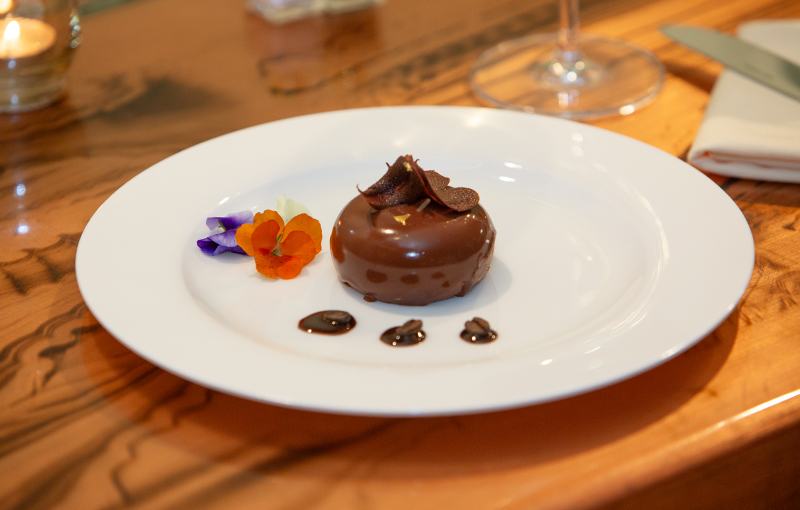 Chocolate dessert with edible flowers