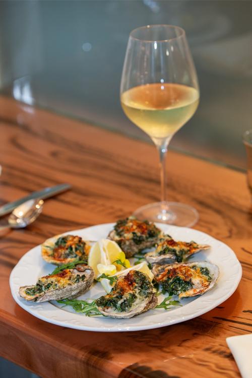 Oysters Rockefeller with a glass of white wine